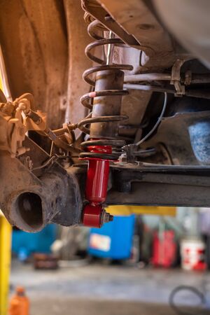 Car Changing New Red Car Absorber In Auto-Repair Service.の写真素材