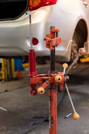 Red Car Absorber Hang On Red Absorber Changing Machine In Auto-Repair Service.の写真素材