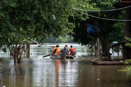 UBON RATCHATHANI, THAILAND- SEPTEMBER 22 : People Ride On Boat To Give Survival Equipment For Flood...