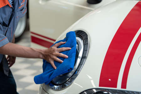Professional Cleans External Car With Blue Microfiber Cloth.