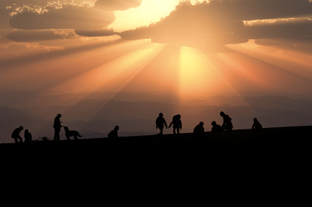 Silhouette of people to walk in the eveningの写真素材