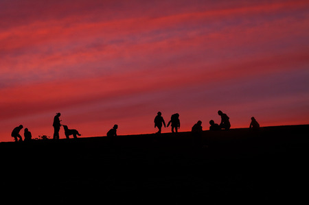 Silhouette of people to walk in the eveningの写真素材