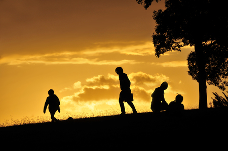 Silhouette of people to walk in the eveningの写真素材