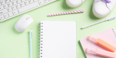 Pastel green back to school flat lay with blank white page, stationery, keyboard, succulent, sneakers. Workspace. Blogging conceptの写真素材