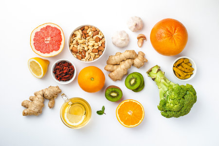 Food for immunity stimulation and viruses protection. Broccoli, citrus fruits, honey, ginger, lemon, garlic, goji, turmeric on white background. Set of different healthy food to boost immune systemの写真素材