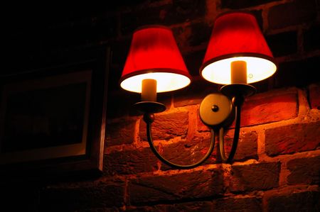 electric lamp on the ancient wall in the night timeの写真素材