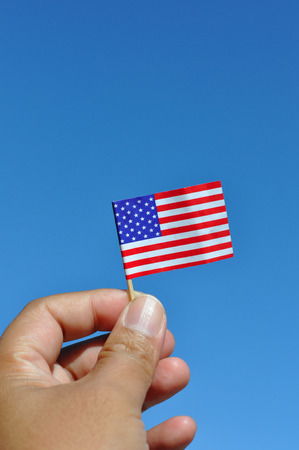 american flag in blue sky patriotic backgroundの写真素材