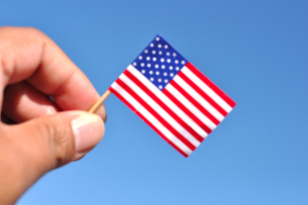 defocused usa flag in blue sky patriotic backgroundの写真素材