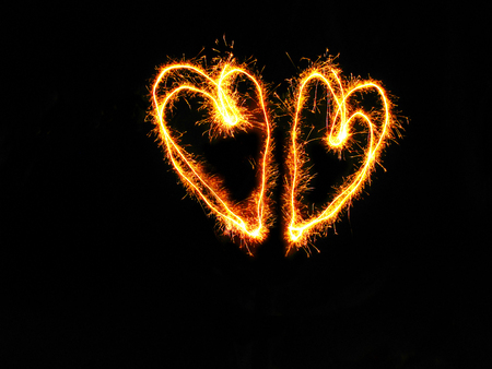 2 hearts by sparkling fireworks on black blackgroundの写真素材