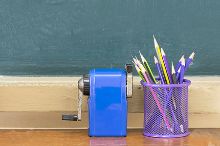 Blackboard, pencil holder, sharpener, booksの写真素材