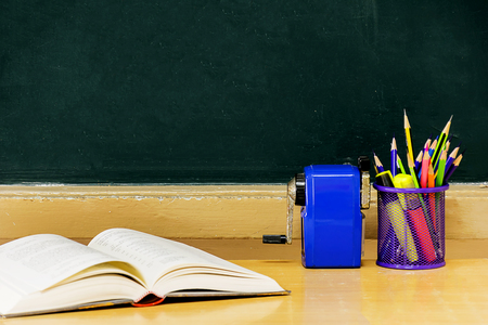 Blackboard, pencil holder, sharpener, booksの写真素材