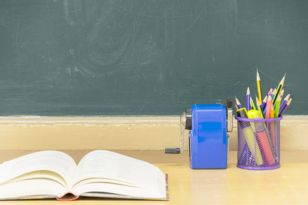 Blackboard, pencil holder, sharpener, booksの写真素材