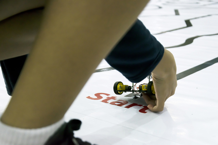 Competition activities for robots, The contestants are students, Get a lot of attention, STEM Learning, Release the robot at the start of the race, The student's leg is the scene.の写真素材