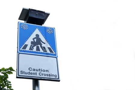 Beware of people or children crossing the street in school zone, Road symbol signs and traffic symbols for roadway, blue board with reflection,A small light bulb that is powered by a solar panel.の写真素材