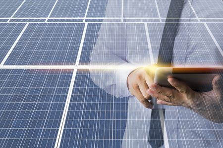 Businessmen calculate investment, breakeven, losses, finances, renewable energy, men wear a White shirt, work with a computer. Internet, modern, solar cell.の写真素材