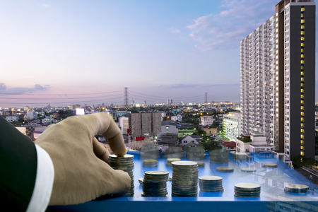 Business competition,Must be analytical,careful,thought into the system,Chess Tournament,The coins are replaced by pieces,Businessman giving a suit,hand catch,The backdrop is a city at night.の写真素材