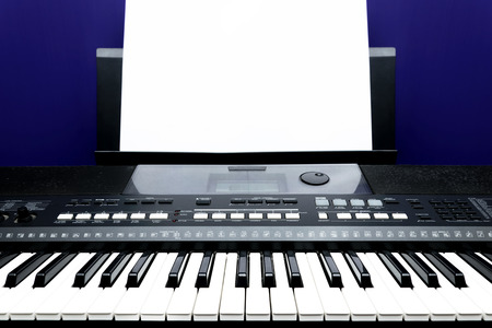 Composing music,Training for self improvement,Close up of Piano and electric piano keyboard,Original midi piano keys in recording studio,Straight face And white paper for writing music notes.の写真素材