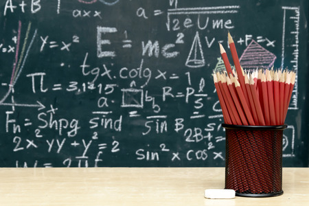 Tools used to create artistic works,Many red pencils Set in a circular arrangement,eraser,The backdrop is Blackboard with mathematical content,Writing with a variety of colors,To stimulate teaching.の写真素材
