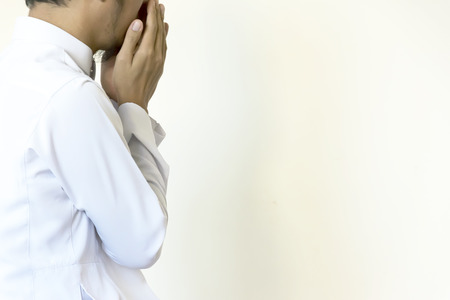 Religious muslim man praying inside the mosque,Men are praying their God Of Islam,Put the pure white dress the two sides to the mouth.の写真素材