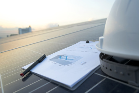 Happy working solar station photovoltaic panels,Science solar energy,engineer working on checking and maintenance equipment at industry solar power,Chart Section Power consumption.の写真素材