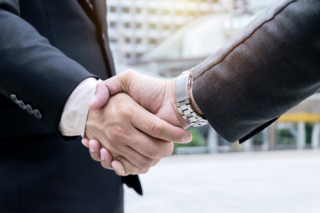 Close up,Success and Happiness concept, Business man handshake at city outside office,two...
