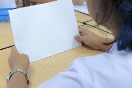 Students are looking at blank white paper,Can be used to enter letters for communication,Group work to practice social skills.の写真素材