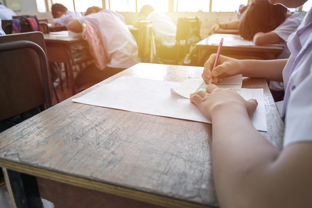 Test the potential of students by taking exams, children are very intent on, exams are placed on the table, pencil handles with black eraser blocks placed.の写真素材