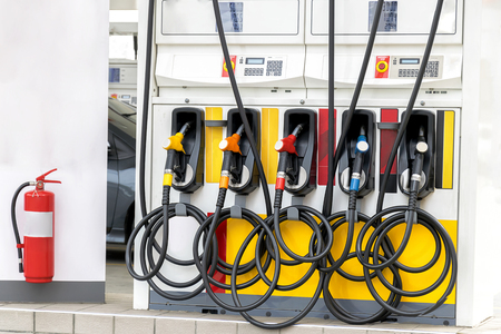 fuel oil gasoline dispenser at petrol filling station,Fire extinguisher is installed for safety.の写真素材