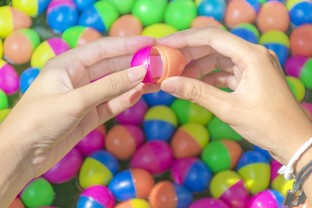 Open to win,Scoop the egg ball in the water game. In plastic eggs besides just filling number of gift.の写真素材