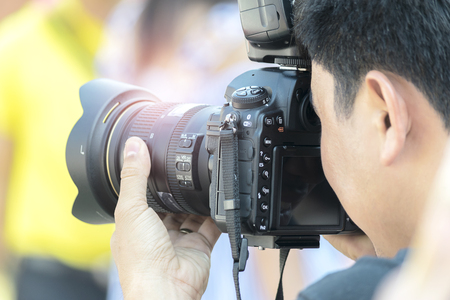 The photographer to pay close attention to take a photo.の写真素材