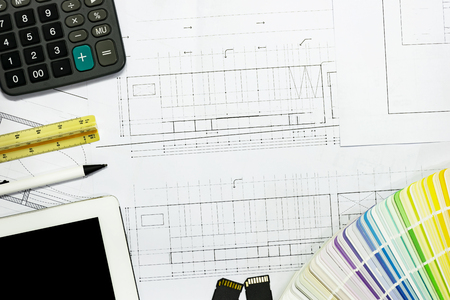 background architects project.blueprint,ruler,pen and Color samples.Concept architects.pointing equipment on the desk with a blueprint in the office.Selective Focusの写真素材