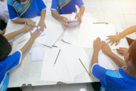 Blurred images of school children doing group learning activities,Helping each other workの写真素材