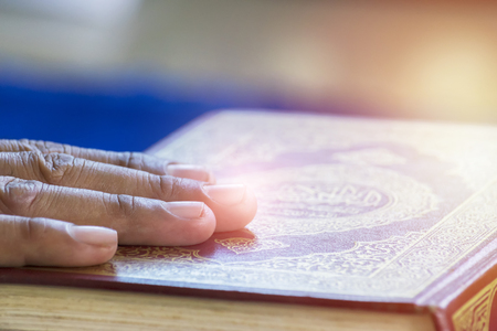 Hands on The Quran is a Book in Islam. Muslims believe that the word of Allah is revealed through the angel Gabriel. To the Prophet Muhammad.Believe  and faith are the beginning of everything.の写真素材