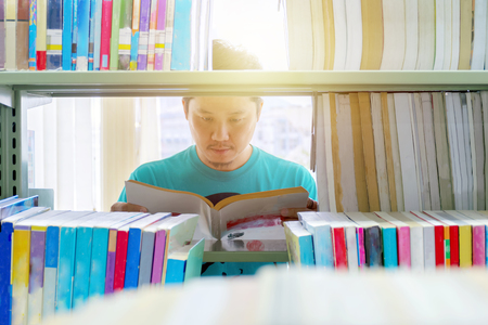 The man is reading books in the library.Reading is the best way to learn.
Enhance knowledge and imagination.The big white book he is reading.A good future is waiting for you.の写真素材