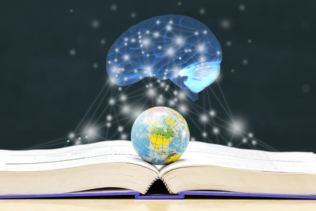 The knowledge contained in the book. Globe placed on the book,Open book on the table, The brain has a glowing appearance. Lines of light like a star Created from the program.の写真素材