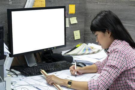 Architects workplace, architectural project,blueprints,ruler.Concept architects.he holding pen pointing equipment architects On the desk with a blueprint in the office.Computer on the sideの写真素材