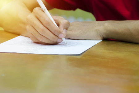 business man signing contract document on office desk, As stated in the agreement. With analytical...