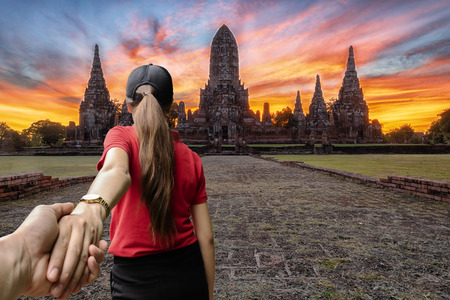 Lover women and men asians travel relax in the holiday.Wat Chai-wat-tha-na Ram The old temple is located at Ban Phra, Amphur Muang, Phra Nakhon Si Ayutthaya. is nourishing, morning light.の写真素材