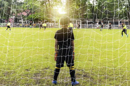 Big dreams of a small boy. There is a need to be a professional footballer. Goalkeeper standing Doing a defense against a business that needs to be protected.のeditorial素材