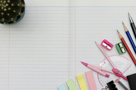 Mathematical accessories. Mathematical instruments over the corner of a math graph paper with copy space for text. Math graphic tools concept.の写真素材