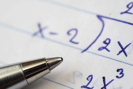 Math problem solving. Must use computational skills. The pen is placed on paper.の写真素材