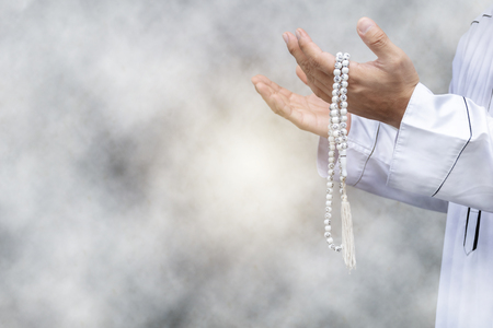Religious muslim man praying inside the mosque,Men are praying their God Of Islam,Put the pure white dress,Hold hands to the front. Faith in Islamic.の写真素材