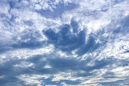 The big white clouds float in the sky, the wind blowing away. Let the clouds move, the sun shines.の写真素材