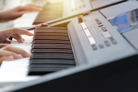 Hands two People of the musician on the Piano keyboard. Music instrument. Black and white key. Play sound, chord, melody. Classical, musical art. Jazz performance, entertainment. Classic note harmony.の写真素材