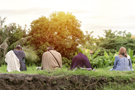 Muslims are sitting in the middle of the lawn in the morning. Islam is a long-standing belief.のeditorial素材
