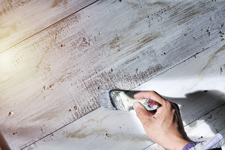 Painters work with paint brushes. Painted white on wooden floor. Beautiful decoration.の写真素材