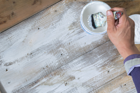 Painters work with paint brushes. Painted white on wooden floor. Beautiful decoration.の写真素材