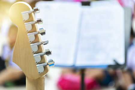Music show. The front of the guitar. The back side is a spread sheet of paper and set on a stand. copy space To enter text.の写真素材