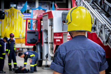Firefighter, fireman. Emergency safety. Protection, rescue from danger. Fire fighter in protective helmet. Adult man, hero in equipment, uniform at work.Teamwork is important.の写真素材