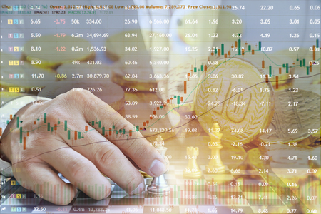 The concept of investing in the stock market, Businessman is playing chess. Good financial planning must be thorough. The background is a lot of gold coins that are placed.の写真素材
